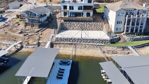 Een meerhoog gebouw met een steiger en een overdekte helling voor boten.
