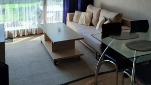 A modern living room with a sofa, coffee table, and glass dining table. - 4 Star Holiday Home in Nykobing Sj (Nykobing Sjaelland)