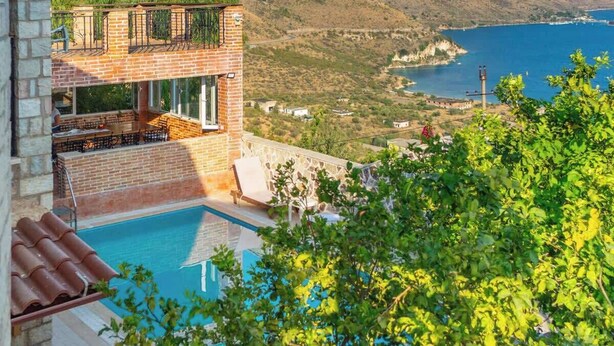 A pool area with a view of the sea and hills. - Ionian Manor Estate villa (Porto Palermo)