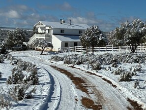 A snow-covered landscape with a white house, a dirt path, and a white fence. - Charming farmhouse on 200 acres in Hesperus, CO overlooking 5,000 acre reserve. (Hesperus)