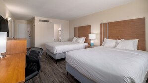 A hotel room with two beds, a desk, a chair, and a bathroom visible through an open door. - Colorado Springs City Core Urban Stay with 2 Queen Beds (Colorado Springs)