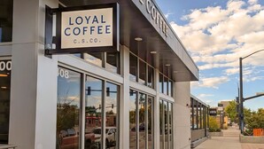 A storefront with a sign reading 'LOYAL COFFEE C.S. CO.' - Colorado Springs City Core Urban Stay with 2 Queen Beds (Colorado Springs)