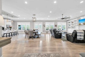 A spacious living area with a dining table, sofas, and a ceiling fan. - 🦩Book Me Baby! Sea Breeze Escape in Santa Rosa Beach🦩 (Santa Rosa Beach)