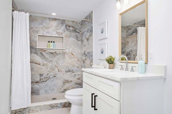 Shower, hair dryer, towels, shampoo