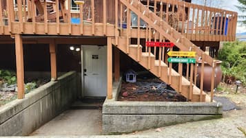 A wooden deck with a staircase leading to a door labeled 'Community Area.'