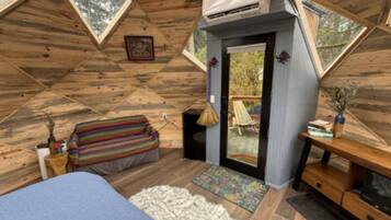 Couch, mini fridge and door to private patio