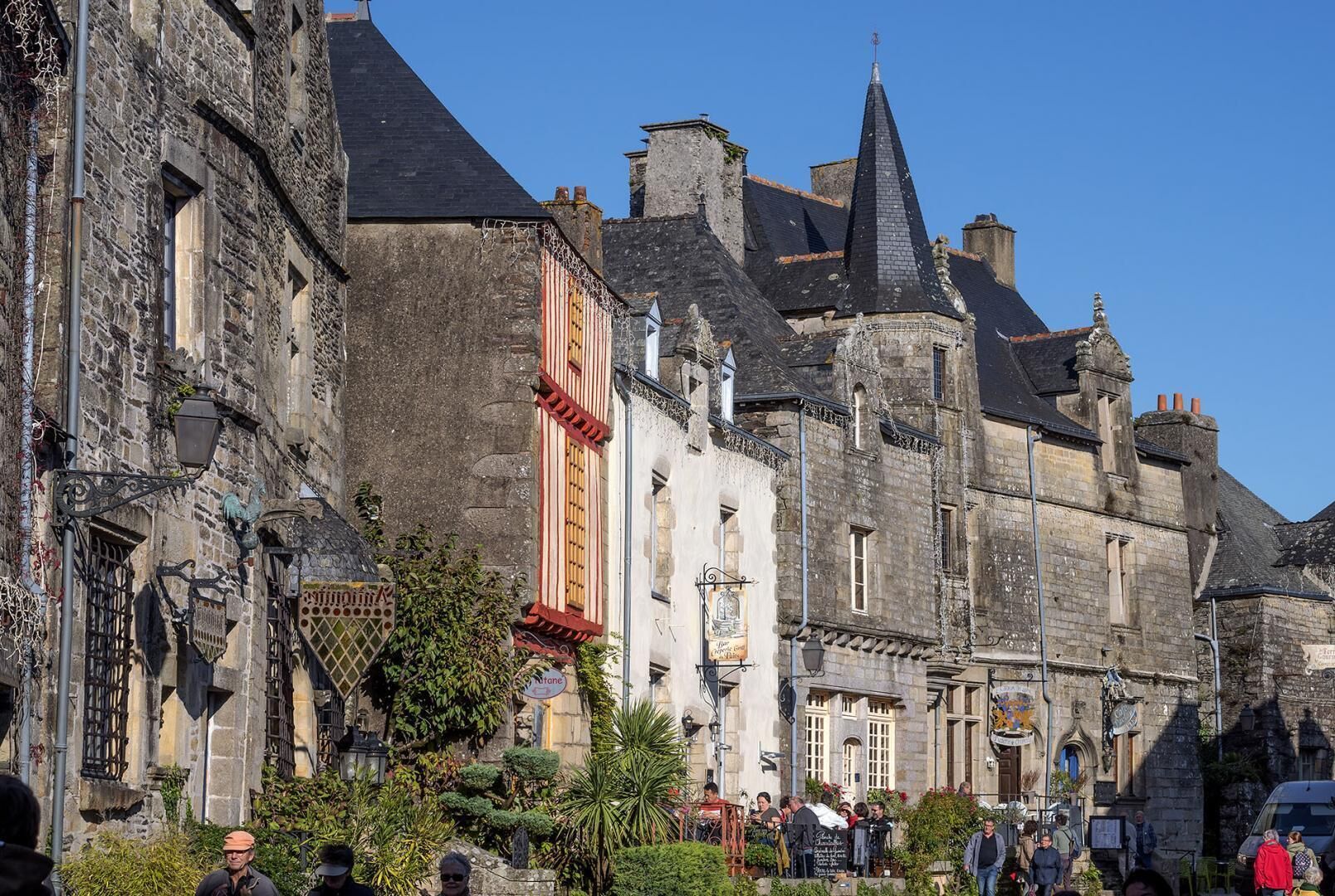 A historic stone building with a prominent tower and a sign indicating a restaurant.