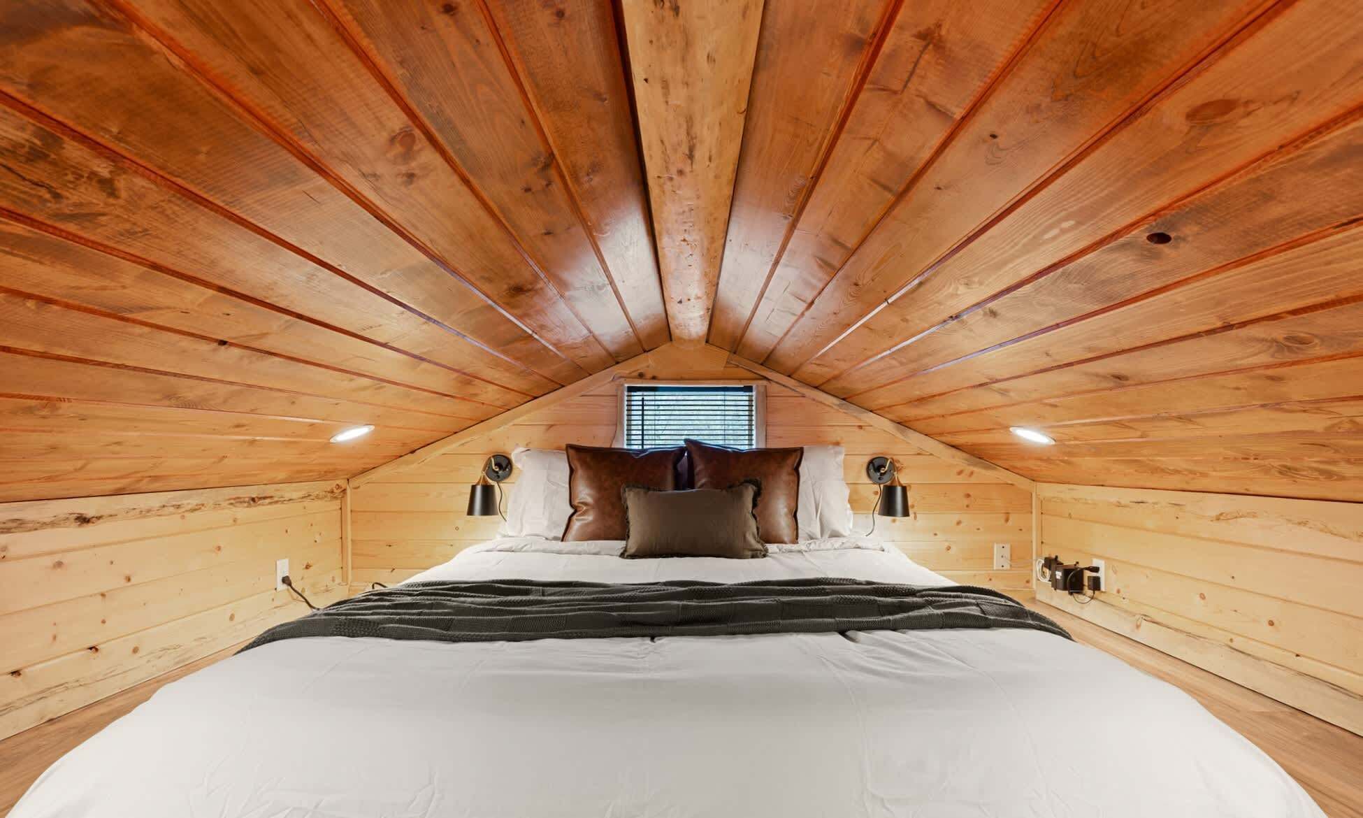 Cozy loft queen bedroom in this Sandpoint tiny cabin (ladder access).