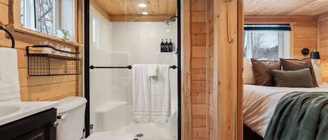 Main floor bedroom and bathroom layout inside this 464 sq ft cabin.