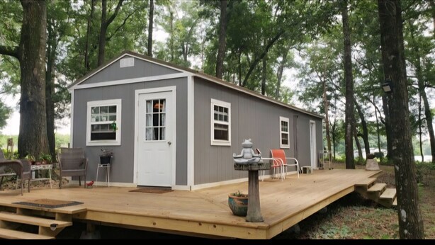 A small, single-story cabin with a front porch, a door, and windows. - Sweet county cabin in the cozy county (Jennings)