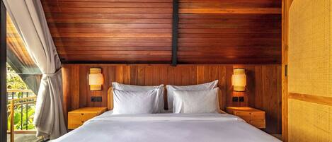 A wooden-paneled room with a bed, two bedside tables, and two wall-mounted lamps.