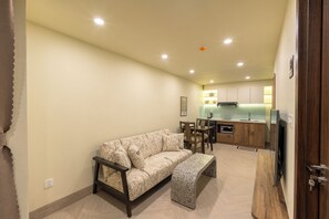 Appartement, 1 très grand lit | Coin séjour