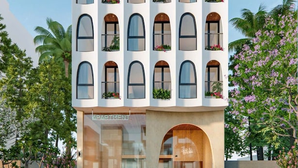 A modern building with multiple balconies, each with plants and flowers, and a large entrance with a sign reading 'APARTMENT'. - Weal Apartment (Da Nang)