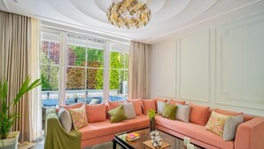 A living room with a sofa, a coffee table, and a potted plant. - ELIVAAS Prive Suntuarios Ikkebana 4 BHK  (Assagao)