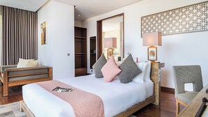 A modern hotel room with a bed, bedside table, chair, and a wardrobe. - Casa Brio Bali (Seminyak)