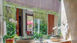 A bathroom with a large mirror, two sinks, and a potted plant. - Casa Brio Bali (Seminyak)