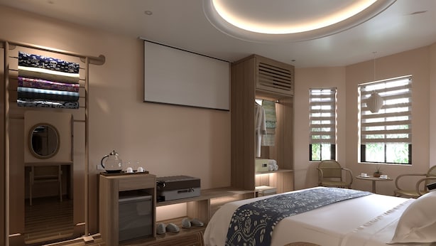 Ein modernes Hotelzimmer mit Bett, Sitzecke, Schreibtisch und großem Fenster.