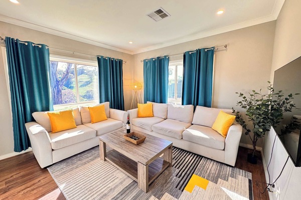Living room with plush sofas and 50" wall mounted smart TV