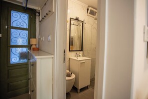 A bathroom with a toilet, sink, and a mirror above the sink. - Casa Nora in Centre of Vodnjan (Vodnjan)