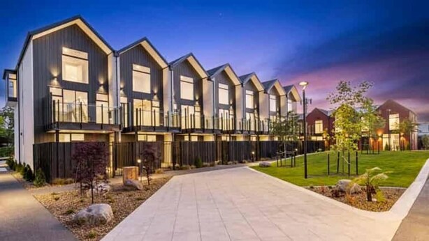 A modern building with a symmetrical facade, large windows, and a paved walkway leading to the entrance. - Merivale Executive Stays (Christchurch)