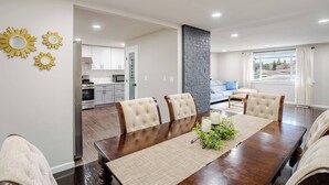 A dining area with a wooden table, four chairs, and a decorative centerpiece. - Serene 4 bedroom house with AC in charming Tacoma (Tacoma)