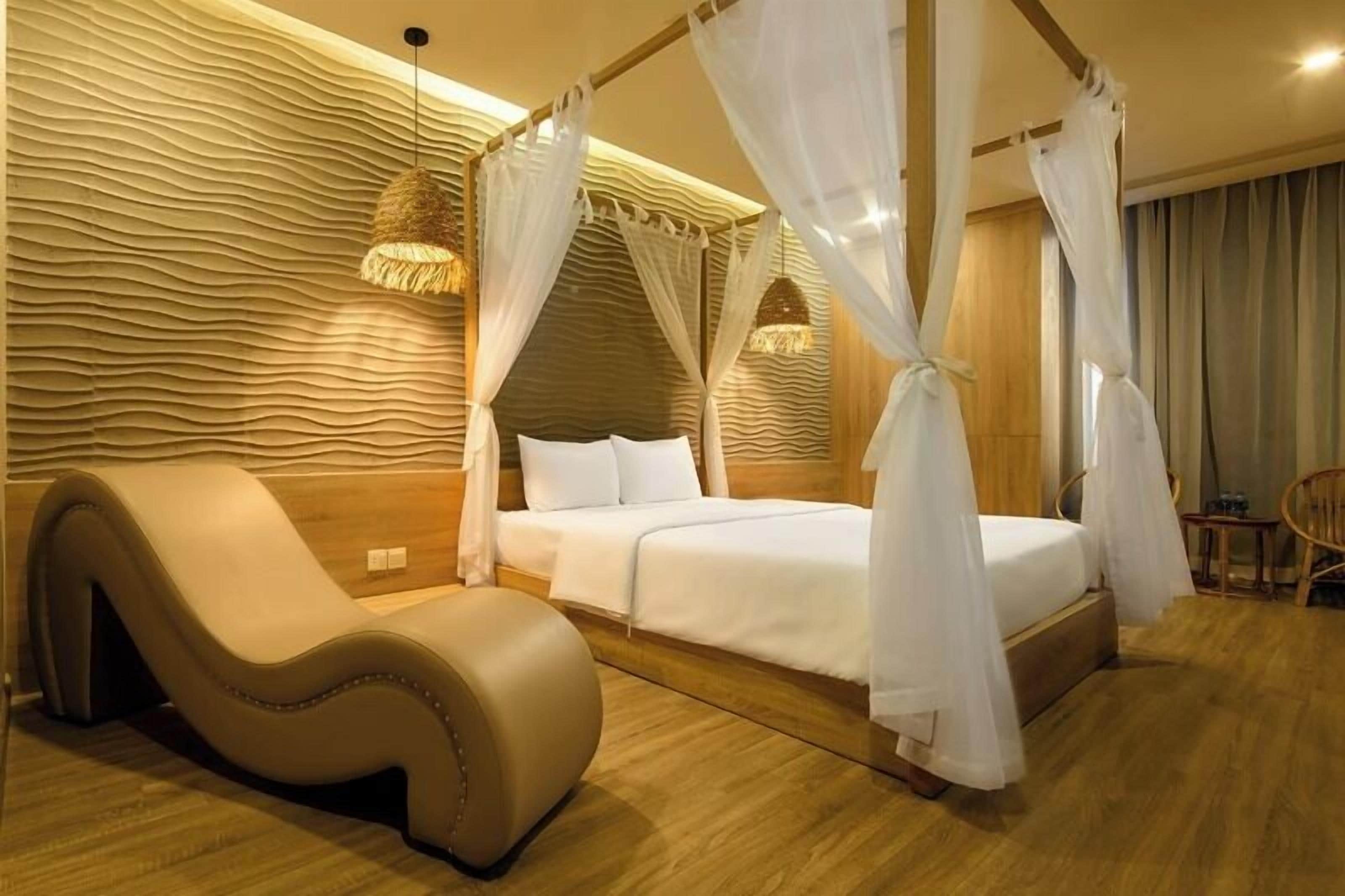 A bedroom with a canopy bed, a massage chair, and a textured wall.