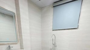 A modern bathroom with a freestanding bathtub, a vessel sink, and a mirror. - One Villa Hotel 6 (Hanoi)