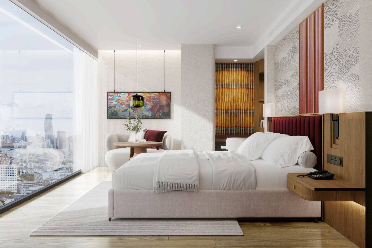 A modern bedroom with a large bed, a city view, a television, and a decorative wall panel.