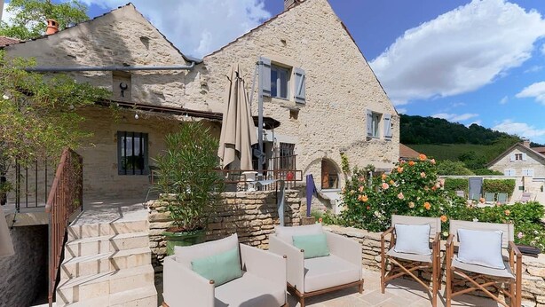 A stone building with a staircase leading to a terrace with outdoor seating. - Villa de luxe La Jonchère, Piscine vue sur les vignes Beaune (Auxey-Duresses)