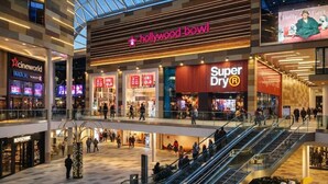 A multi-level shopping mall with stores like Hollywood Bowl, Super Dry, and Uniqlo. - Elegant Flat | 2-Min Walk to Watford Junction (Watford)