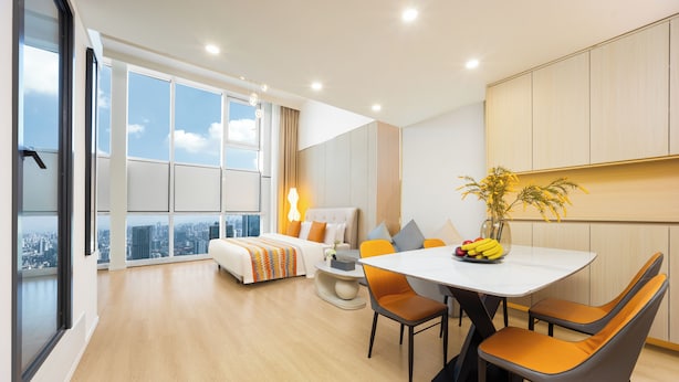 A modern hotel room with a large bed, a dining table with chairs, a small round table, and a large window offering a city view. - The HEJINN House - Design Lofts & Suites (Chengdu)