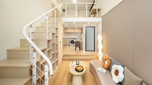A modern interior with a staircase, a dining area, and a sofa with decorative pillows. - The HEJINN House - Design Lofts & Suites (Chengdu)