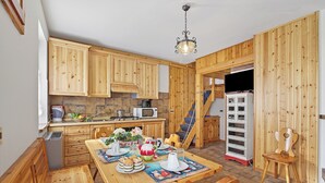 A wooden interior with a kitchen, dining area, and a staircase. - Casa Maria - Mountain Sports Base (Pievepelago)