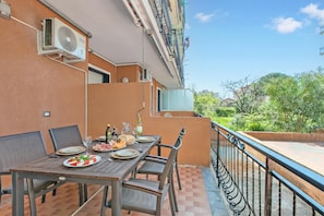 An outdoor dining area with a table set for two, chairs, and a view of greenery. - La Genzianella - Studio for 4 With Balcony & AC (Andora)