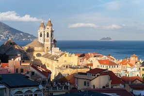 A coastal town with a prominent church, colorful buildings, and a view of the sea. - La Genzianella - Studio for 4 With Balcony & AC (Andora)