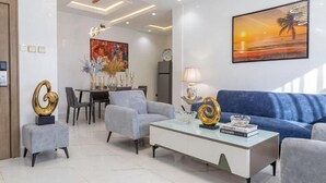 A modern living room with a sofa, coffee table, and decorative items.