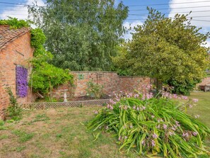A brick building with a garden, a tree, and a fence. - Wards Court 1, Frampton On Severn (Gloucester)
