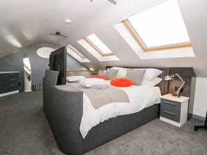 A modern bedroom with skylights, a bed, bedside tables, and a wardrobe. - The Annex, Ulverston (Ulverston)