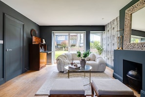 A modern living room with a sofa, coffee table, and fireplace. - The Old Chase, Chester (Chester)