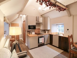 A compact kitchen with a microwave, oven, and sink. - Maltkiln House Annexe, Stokesley (Middlesbrough)