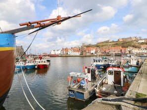 A harbor with boats docked, a pier, and a town in the background. - Dale View, Lealholm, Whitby (Whitby)