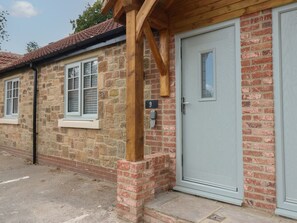 A stone building with a light grey door, a number 9 sign, and a window with shutters. - Spacious Cottage Number 9, Brandon, County Durham (Durham)