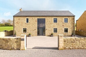 A stone building with a central entrance, multiple windows, and a gravel driveway. - Archstone House, Langho, Lancashire (Blackburn)