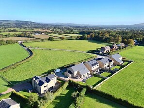 A rural property with multiple buildings, a large green field, and a stone wall. - Archstone House, Langho, Lancashire (Blackburn)