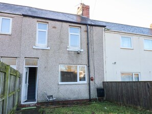 A residential building with a front door, windows, and a small garden area. - 16 Salvin Terrace, Fishburn (Stockton-on-Tees)