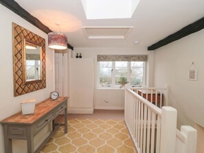A room with a skylight, a wooden desk, a mirror, a window with a valance, and a white railing. - The Cottage Loaf, Wedmore (Wedmore)