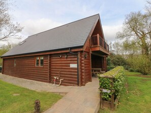 A log cabin with a sloped roof, a balcony, and a sign labeled 'ASPEN.' - Aspen Retreat in Dolton, Devon (Winkleigh)