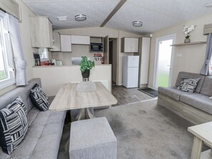 A compact living space with a kitchenette, a dining area, and a seating area.