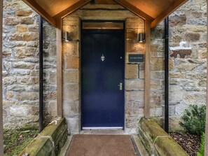 A stone building entrance with a dark blue door, a sign reading 'Low Moor House,' and a small porch area. - Low Moor, Easington, Yorkshire (Saltburn-by-the-Sea)