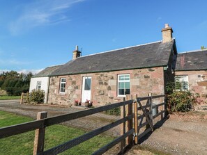 A stone house with a wooden fence, a gravel driveway, and a clear blue sky. - The Bothy, Blairgowrie (Blairgowrie)